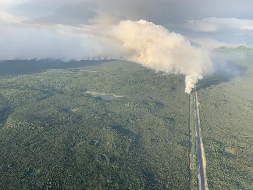 A plume of smoke rises near the Sterling Highway in this aerial photo.