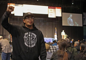 Alaska Native organizer and activist Samuel Johns protests during a speech by Gov. Mike Dunleavy at the 2019 Alaska Federation of Natives Conference at the Carlson Center in Fairbanks.