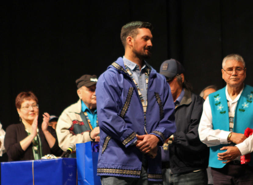 Pete Kaiser receives gifts and awards after his speech at the 2019 Alaska Federation of Natives Conference at the Carlson Center in Fairbanks.