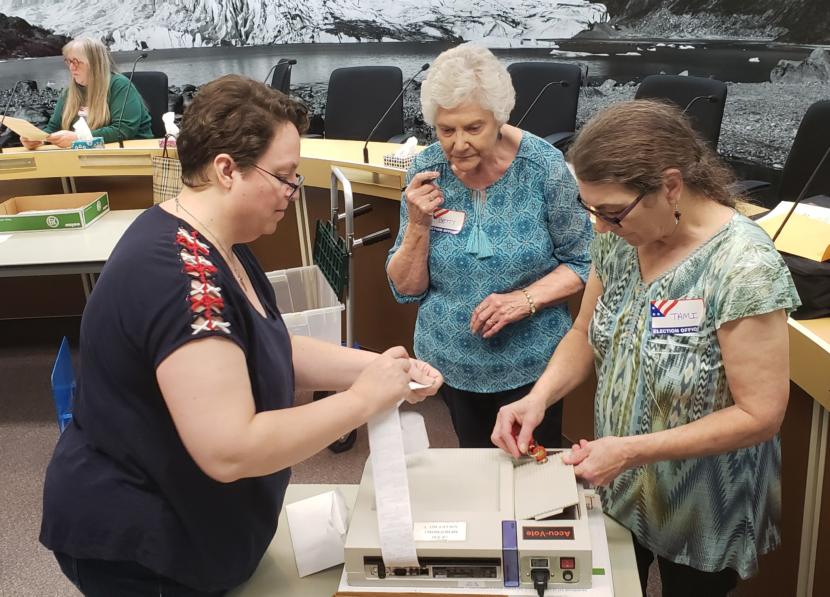 Juneau City Clerk Beth McEwen closes out an AccuVote machine count of absentee and questioned ballots with election workers Betty Cook and Tami Burgett at City Hall on Friday, Oct. 4, 2019.