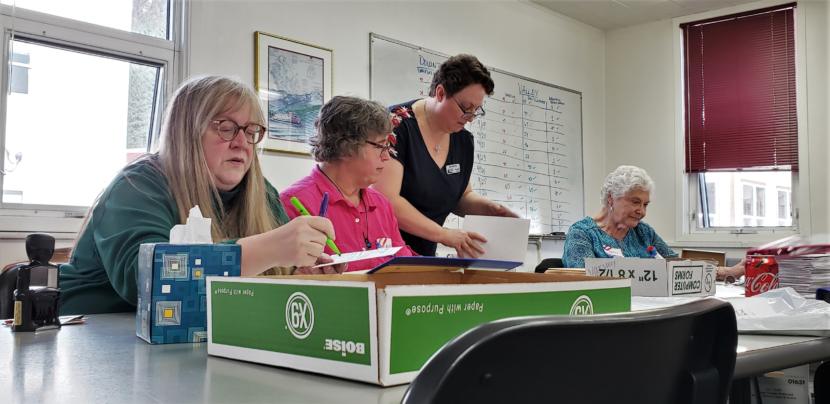 Juneau election workers check absentee and questioned ballots in a conference room at City Hall on Friday, Oct. 4, 2019. From left to right: Hali Denton, Andy Peterson, Beth McEwen and Betty Cook.