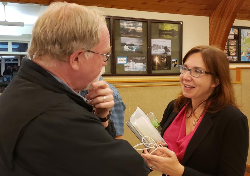 Deacon Charles Rohrbacher of the Catholic Diocese of Juneau talks with climate scientist and Evangelical Christian Katharine Hayhoe at Chapel by the Lake in Juneau on Sept. 13, 2019. Hayhoe, a Texas Tech University professor, said she stacked 29 events around Alaska into her trip.