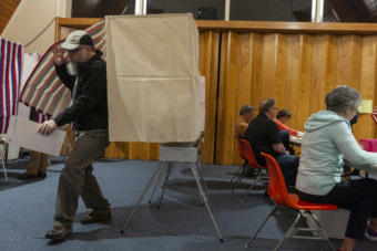 A voter leaves the booth as election workers at Northern Light United Church assist other voters during Municipal Elections on October 1, 2019, in Juneau, Alaska. (Photo by Rashah McChesney/KTOO)