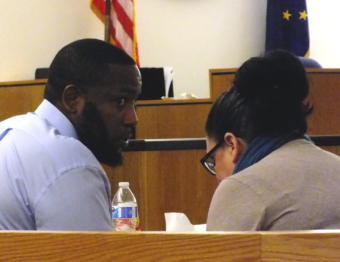 Defendant Laron Graham confers with his attorney Natasha Norris during a break in closing arguments Monday, Oct. 7, 2019. in the double homicide trial in Juneau Superior Court.