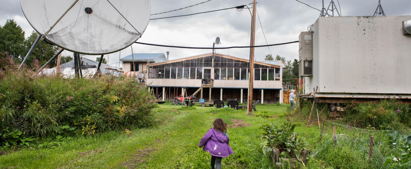 Coryn Nicoli runs through her backyard in Red Devil, Alaska on August 16, 2019. Nicoli lives with her parents in Red Devil but when she starts school, she will either have to be home-schooled or leave the village since there is not a school in Red Devil. (Katie Basile/KYUK)