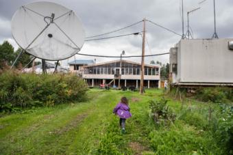 Coryn Nicoli runs through her backyard in Red Devil, Alaska on August 16, 2019. Nicoli lives with her parents in Red Devil but when she starts school, she will either have to be home-schooled or leave the village since there is not a school in Red Devil. (Katie Basile/KYUK)