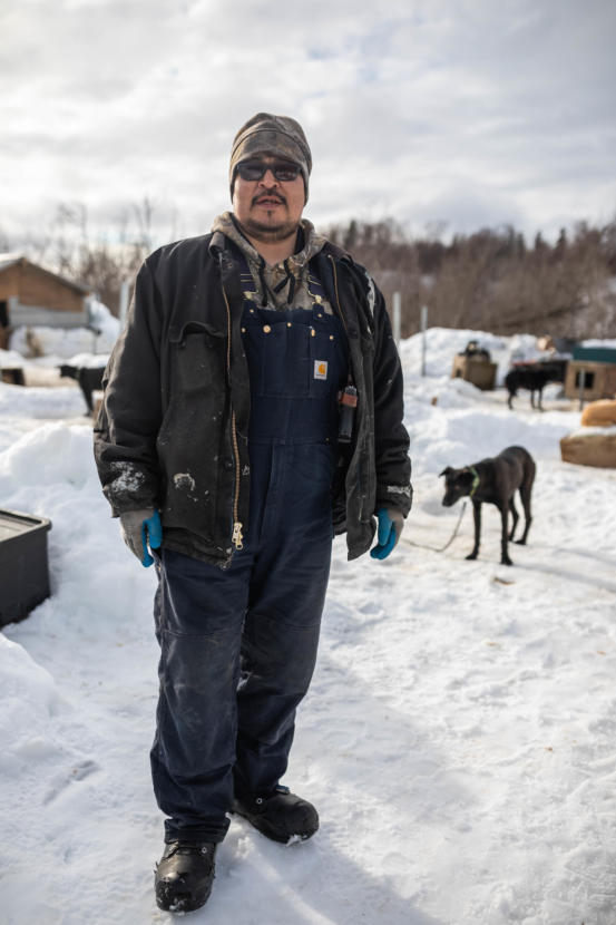 Basil Larson stands in his dog yard on March 8, 2019 in Russian Mission. He often carries a handgun while mushing for protection from wildlife. (Loren Holmes / ADN)