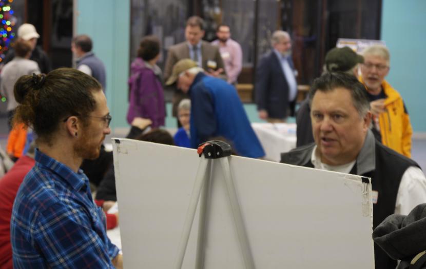 Chuck Collins, facing, discusses the Egan Drive-Yandukin Drive project with DOT environmental engineer Ben Storey at the Nugget Mall in Juneau on Nov. 19, 2019. DOT was holding an open house as part of its planning process for possible improvements to the intersection.