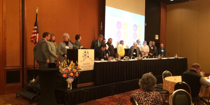 Mayors and representatives from 15 Alaska communities sign an agreement establishing a statewide commission to coordinate online sales tax collection. The ceremony took place at the annual Alaska Municipal League conference in Anchorage on Thursday, Nov. 21, 2019. (Photo courtesy of Michelle Hale)
