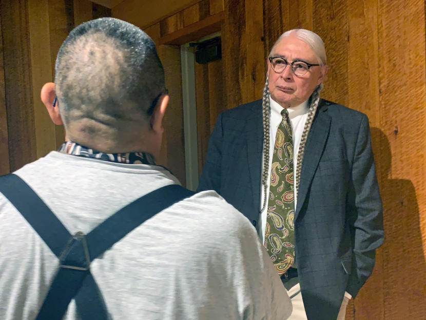 Walter Echo-Hawk talks to a man after giving a speech on the 1955 Tee-Hit-Ton Tlingit loss of a Supreme Court case on November 8, 2019, in Juneau, Alaska. (Photo by Rashah McChesney/Alaska's Energy Desk)