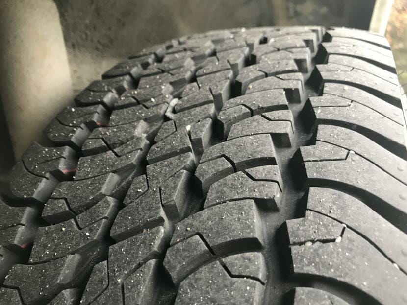 A closeup shot of the treads on a tire.