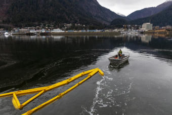 Petro Marine employees deploy bright yellow boom around their dock on Wednesday, Nov. 6, 2019 in the Gastineau Channel. The company is drilling its response to contain oil spills.