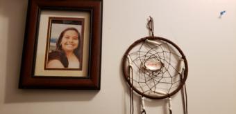 A photo of Abby Kelley and a dream catcher hang on a wall in her family's home in Juneau on Dec. 2, 2019. Her parents say that she "had dimples for days."