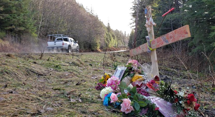 Traffic zooms by a makeshift memorial to Abby Kelley near Mile 21 of Glacier Highway in Juneau on Dec. 2, 2019. Kelley, 19, and Keith Brososky Jr., 15, died after the car they were riding in sped off the road nearby on Nov. 21, 2019.