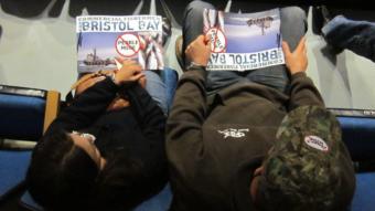 Activists hold anti-Pebble Mine posters at an EPA meeting in 2012. Photo by Daysha Eaton.