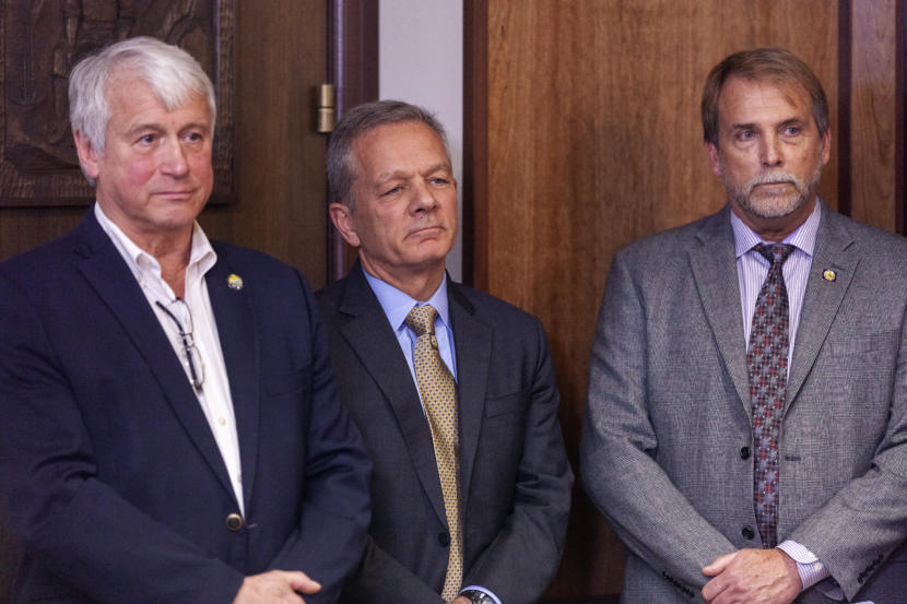 Department of Transportation and Public Facilities Commissioner John MacKinnon, Gov. Mike Dunleavy's Chief of Staff Ben Stevens, and Senior Policy Advisor Brett Huber watch a press conference unveiling Dunleavy's budget proposal on Wednesday, December 11, 2019, at the Capitol in Juneau, Alaska. (Photo by Rashah McChesney/KTOO)