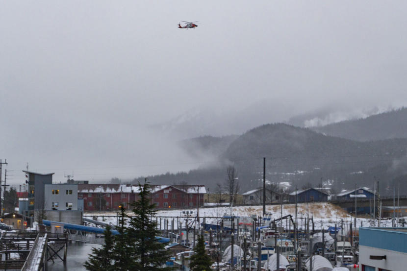 A Coast Guard helicopter hovers over Harris Harbor on Thursday, Jan. 23, 2020, in Juneau, Alaska. (Photo by Mikko Wilson/KTOO)