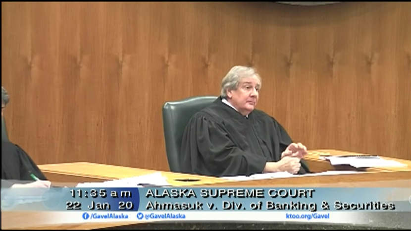 Supreme Court justice Daniel Winfree questions the state’s broad authority to regulate shareholder speech during Wednesday’s oral arguments in a case that tests the limit of free speech in Alaska Native corporation board elections. (Screenshots courtesy of KTOO/Gavel Alaska)