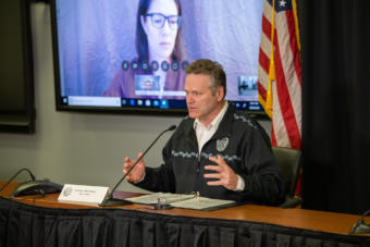 Alaska Gov. Mike Dunleavy speaks at a news conference on COVID-19 in Anchorage, Thursday, March 26, 2020. Chief Medical Officer Dr. Anne Zink spoke remotely and appeared on a TV screen to the governor's right. (Creative Commons photo courtesy Alaska Governor's Office)
