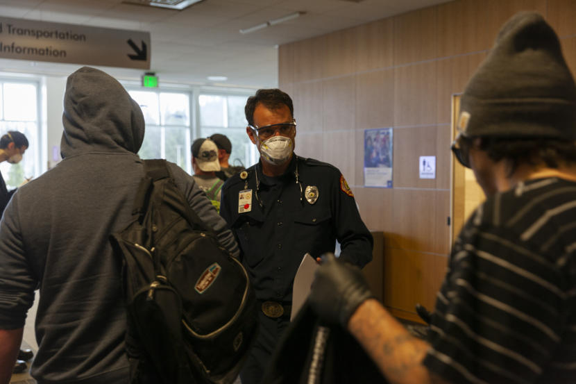 Capital City Fire/Rescue Capt. Roy Johnston talks to people arriving at Juneau International Airport on Saturday, March 21, 2020 in Juneau, Alaska.