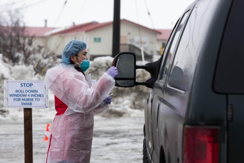 Registered Nurse Avelina Chung runs through protocol with a YKHC employee at the COVID-19 drive-thru test site on March 25, 2020 in Bethel, Alaska. Credit Katie Basile / KYUK