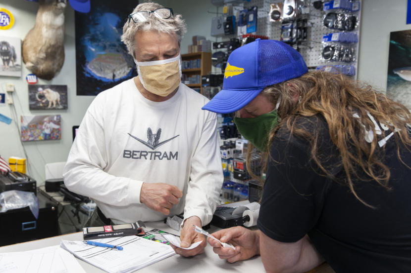 Art Sutch talks to Kyle Willingham about camera card adaptors on Saturday, April 25, 2020, in Juneau, Alaska. Sutch is closing his brick-and-mortar camera shop in downtown Juneau after 25 years in business. (Photo by Rashah McChesney/KTOO)