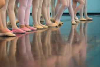 A row of ballet dancers' feet.