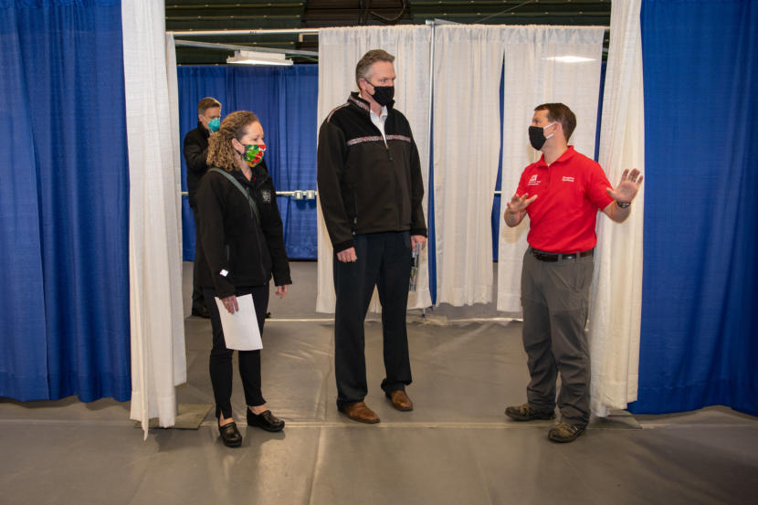 Alaska Gov. Mike Dunleavy, center, takes a tour of the Alaska Airlines Center in Anchorage on April 15, 2020.