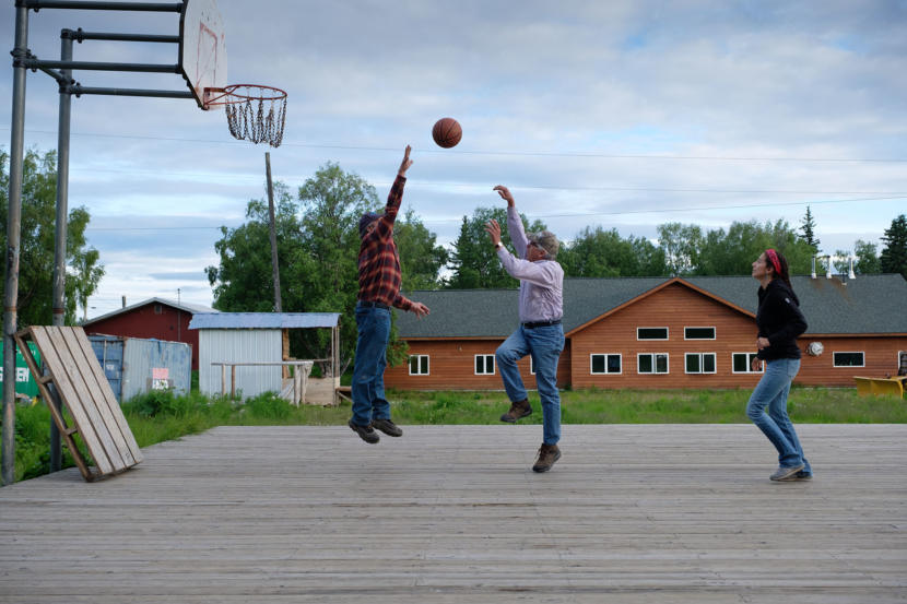 Then-Lt. Gov. Byron Mallott and Department of Fish and Game Commissioner Sam Cotton play basketball against Natasha Singh from the Tanana Chiefs Council in Grayling on June 26, 2018. 