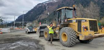 SECON worker Dartanan Campos hops into the cab of construction equipment near the intersection of Egan Drive and 10 Street in Juneau on May 6, 2020.