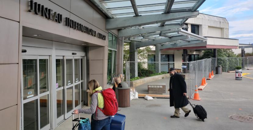 Travelers head into the terminal of Juneau International Airport on May 15, 2020.