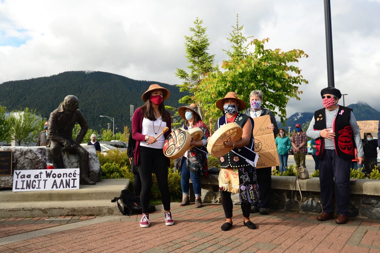 Dionne Brady-Howard, whose Tlingit name is Yeidikoo’aa, drums and leads a song after speaking to the crowd about why she wants the city to relocate the statue of Alexander Baranov: “No, it is not about political correctness. It is about accuracy. The teaching of accurate history is the only thing that keeps us from repeating those mistakes.” (Berett Wilber/KCAW)