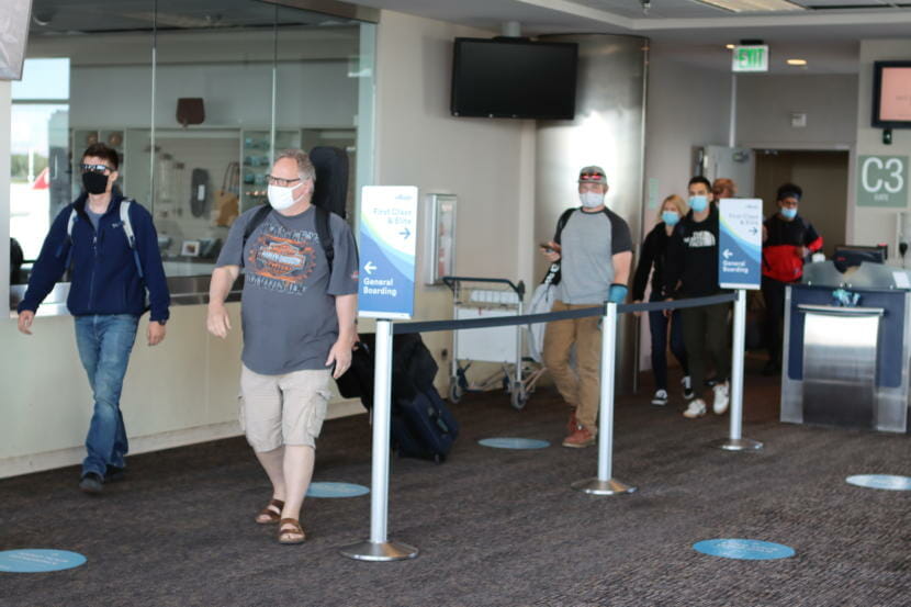 Travelers disembark a plane from Seattle at Ted Stevens Anchorage International Airport