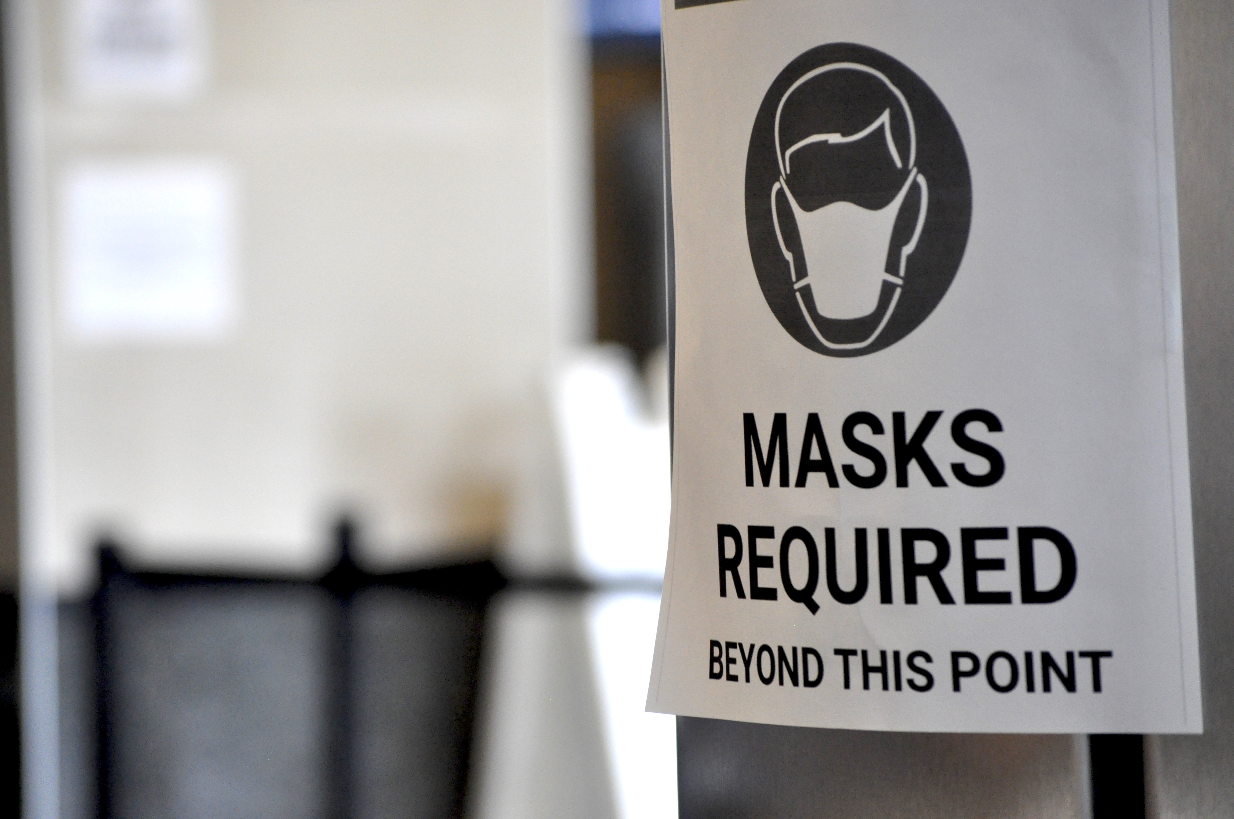 A sign at the Ted Stevens Anchorage International Airport near where people can get tested for COVID-19 (Liz Ruskin/Alaska Public Media)