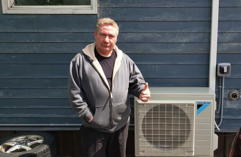 Ray Lindoff poses next to his new air-source heat pump at his home in downtown Juneau on June 5, 2020.