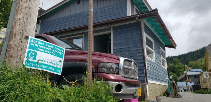 A Juneau Carbon Offset yard sign stands at the corner of Ray Lindoff's home in downtown Juneau on June 5, 2020. 