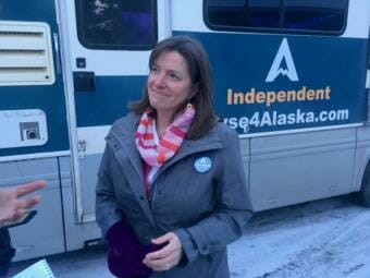 Independent Alyse Galvin standing in front of her campaign bus