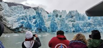 Passengers aboard Adventure Bound Alaska's vessel Captain Cook photograph the South Sawyer Glacier calving in Tracy Arm fjord on June 13, 2020.