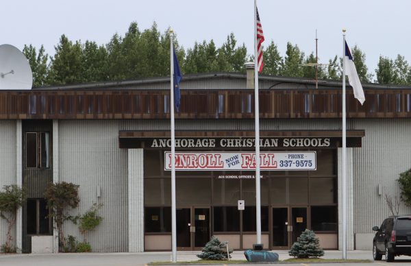 The entrance to Anchorage Christian Schools, including a banner advertising fall enrollment.