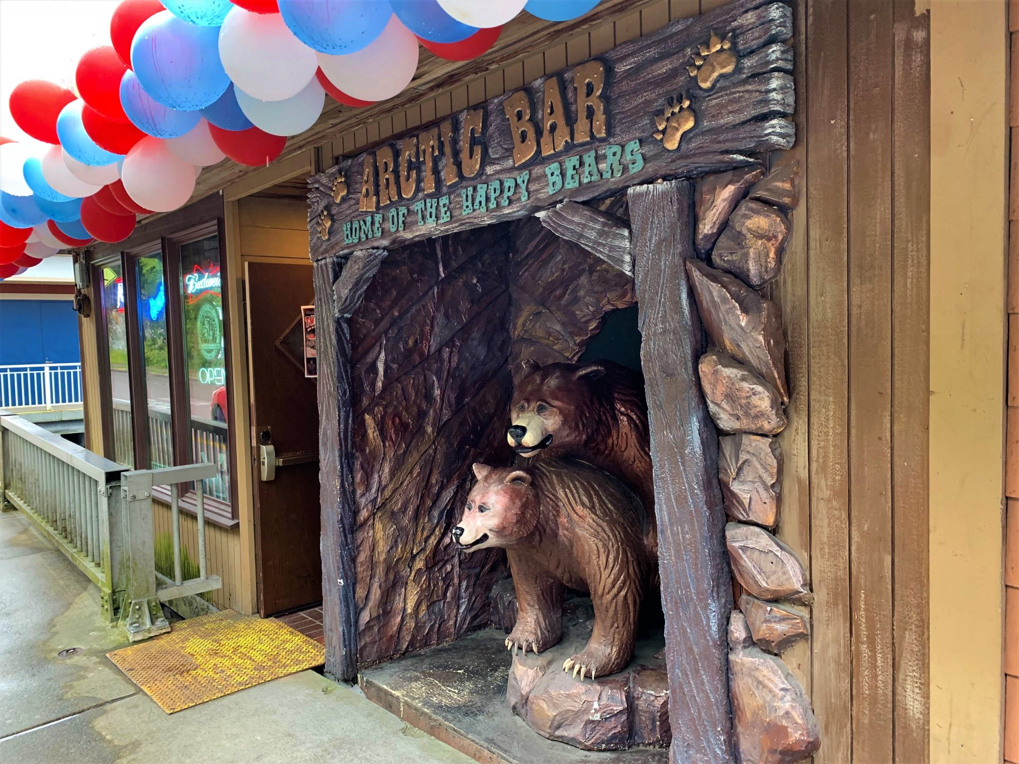 Two bear statues and balloons greet patrons at the Arctic Bar’s entrance in Ketchikan.