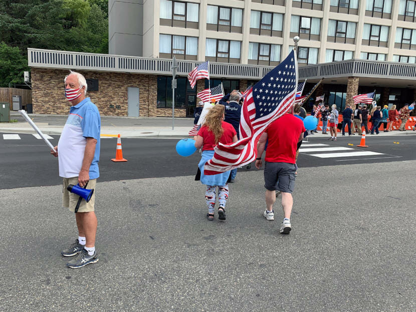 Former Juneau Mayor Ken Koelsch helps guide dozens of people who marched through downtown during a Saturday, July 4, 2020, Back the Blue rally in Juneau, Alaska.