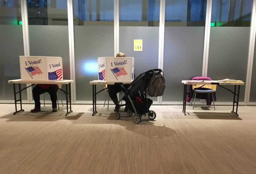 Voters fill out their ballots just an hour before voting was to end in Juneau's municipal elections on Oct. 6, 2020, at Juneau Public Libraries' Valley Branch. Most voters cast their votes by mail, but some went to vote in person. (Photo by Andrew Kitchenman/KTOO and Alaska Public Media)