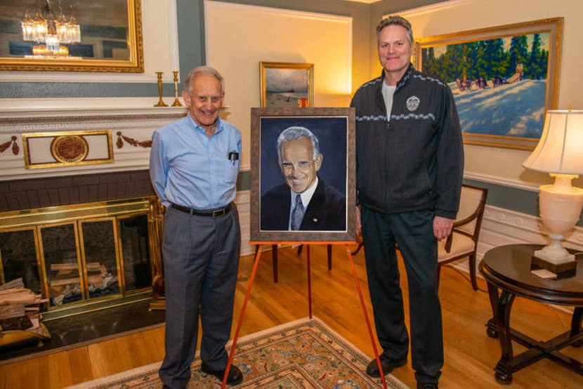 Dick Randolph poses with Gov. Mike Dunleavy and a painting of himself