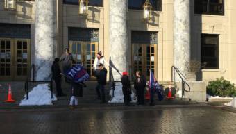 Supporters of President Donald Trump hold a protest in front of the Alaska State Capitol.