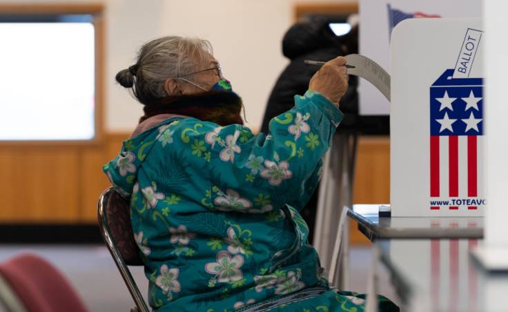 Edna Mathlaw of Bethel reads her ballot on Nov. 3, 2020 in Bethel, Alaska. (Photo by Katie Basile / KYUK)