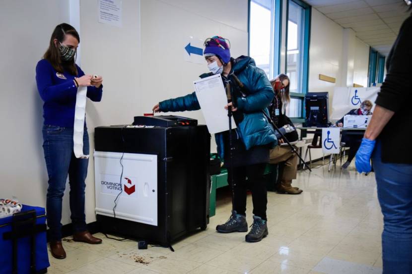 Election workers help a voter at Service High School in Anchorage on November 3, 2020. (Jeff Chen/Alaska Public Media)