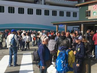 Passengers from the mega ship Norwegian Joy disembark in May 2019 at Ketchikan’s Berth 3 downtown. (Photo by Leila Kheiry/KRBD)