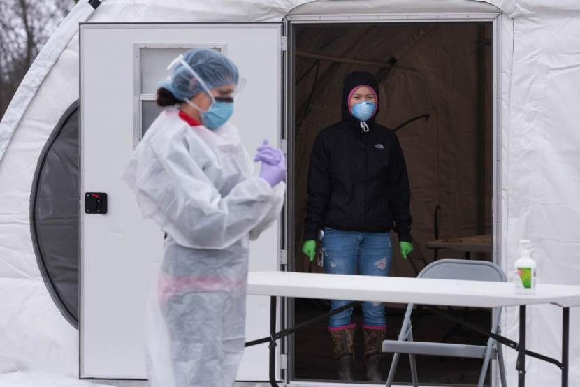 Yukon-Kuskokwim Health Corporation workers wait to perform COVID-19 tests