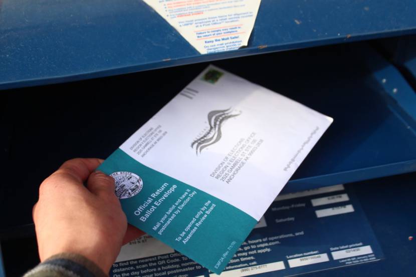 A voter mails an absentee ballot in October 2020.