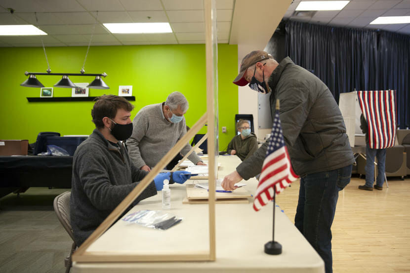 Voters sign for their ballots at the Auke Bay precinct on Tuesday, Nov. 3, 2020, in Juneau, Alaska. (Photo by Rashah McChesney/KTOO)